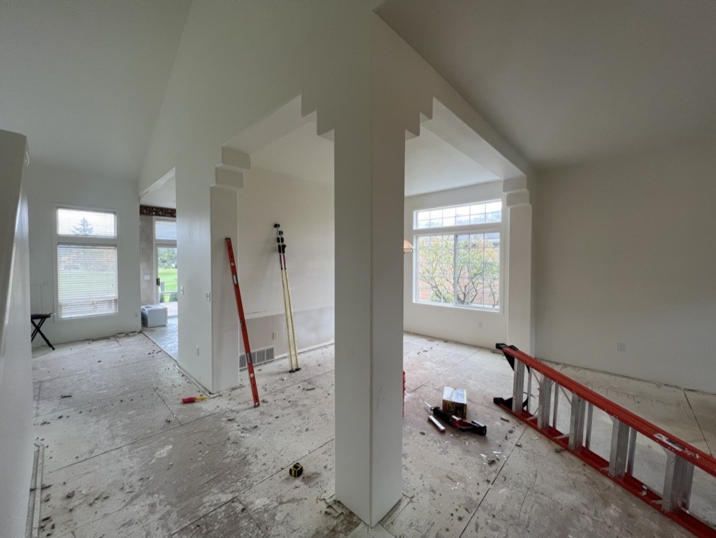 A kitchen wall opened up during a structural renovation, with the new openings framed
